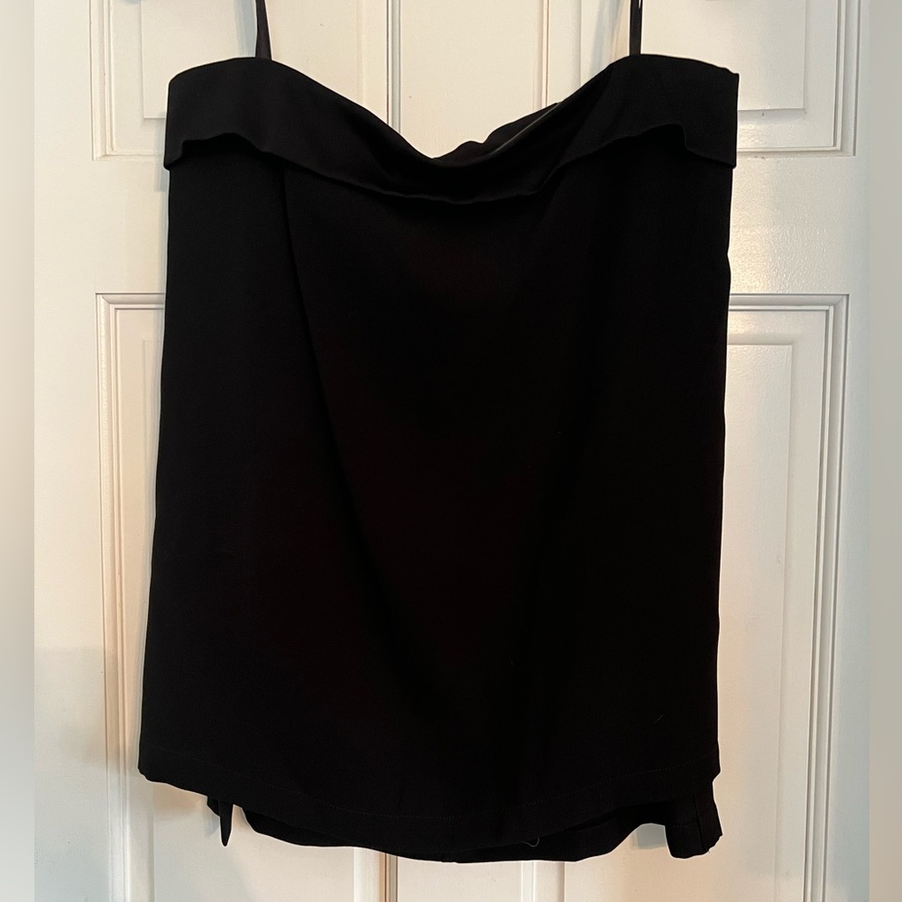 BCBG black sleeveless top. There is some bone-ing. Zip up with buttons in back.